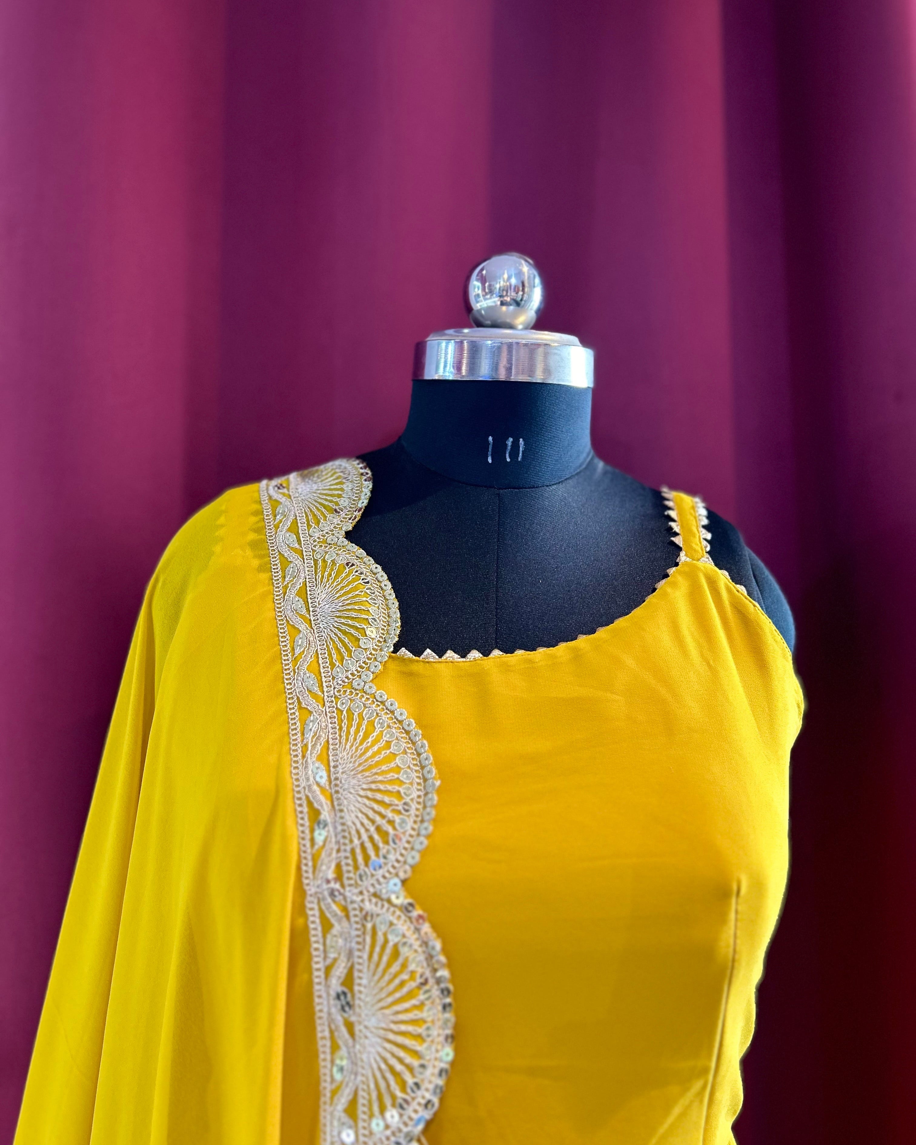 Yellow Anarkali with golden cutwork dupatta.