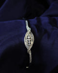 Silver bracelet with diamonds on a dark blue fabric background