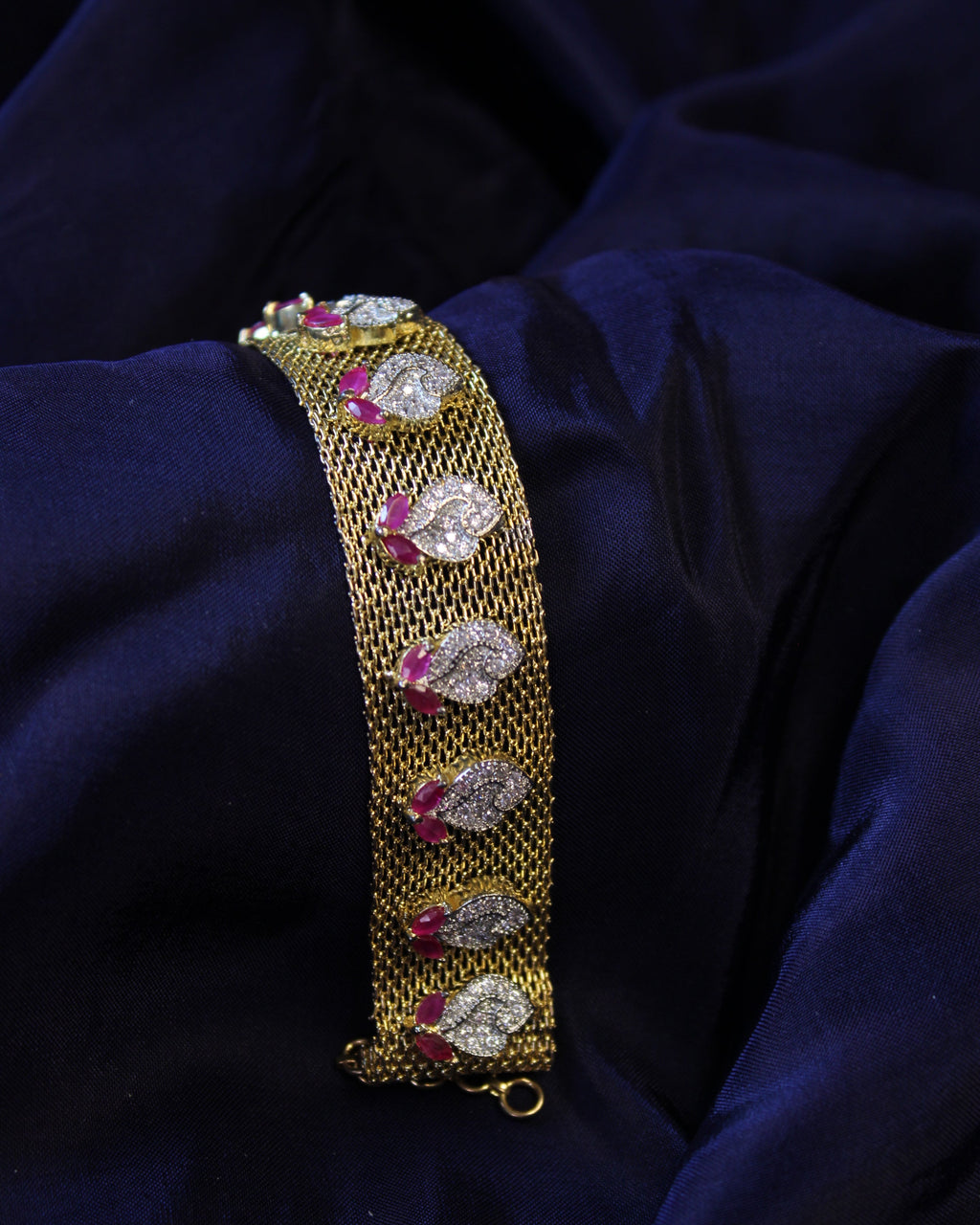 gold bracelet with clear diamond and red ruby stones